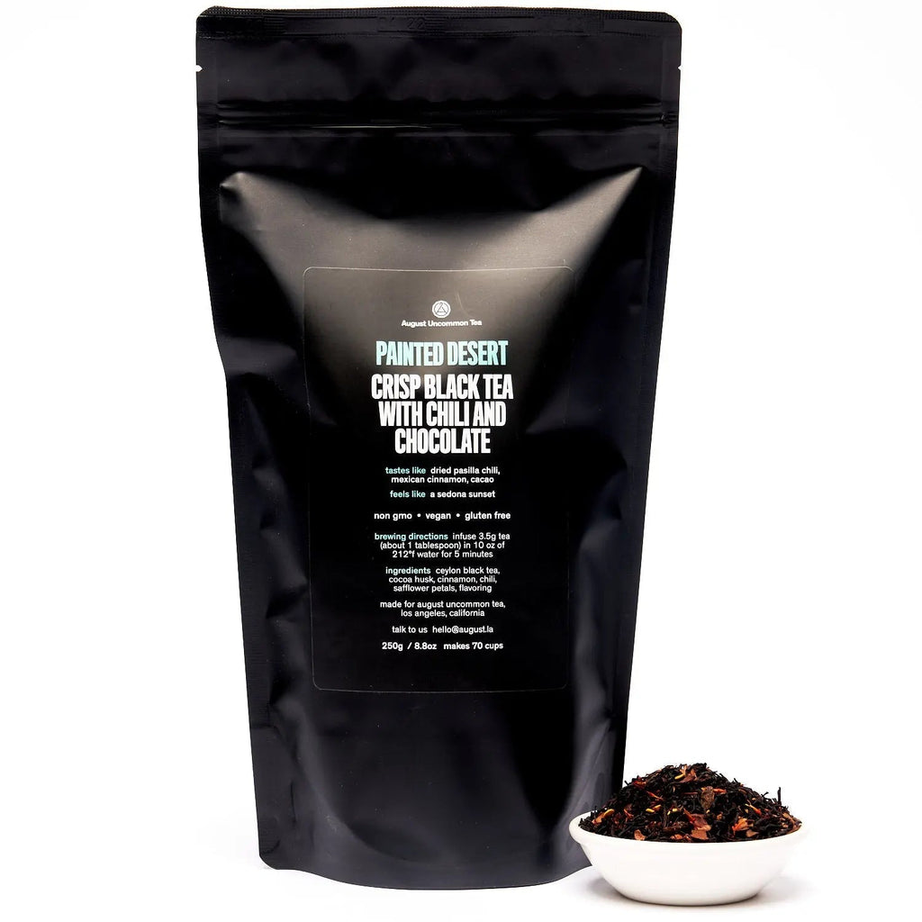 Cup of Painted Desert Chocolate Chili Black Tea with cinnamon and chili spices on wooden table