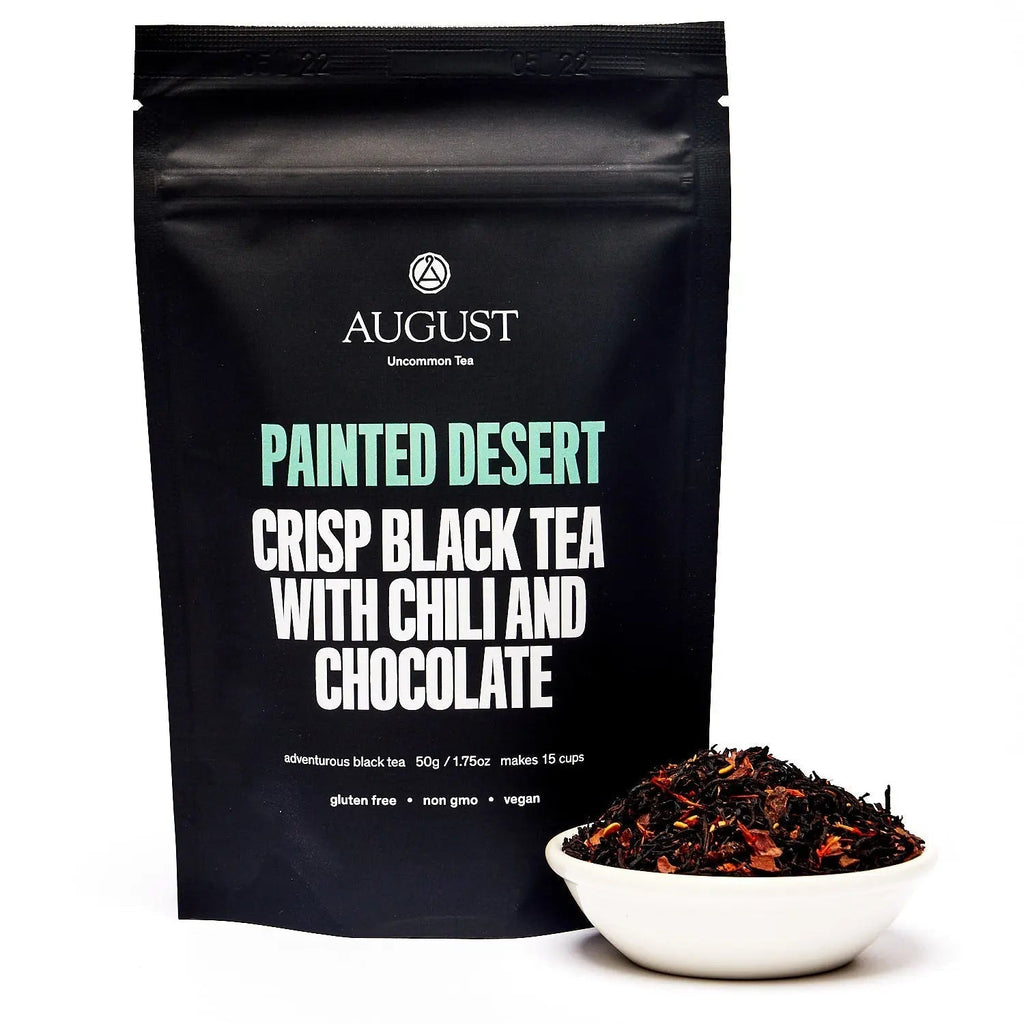 Cup of Painted Desert Chocolate Chili Black Tea with cinnamon and chili spices on wooden table