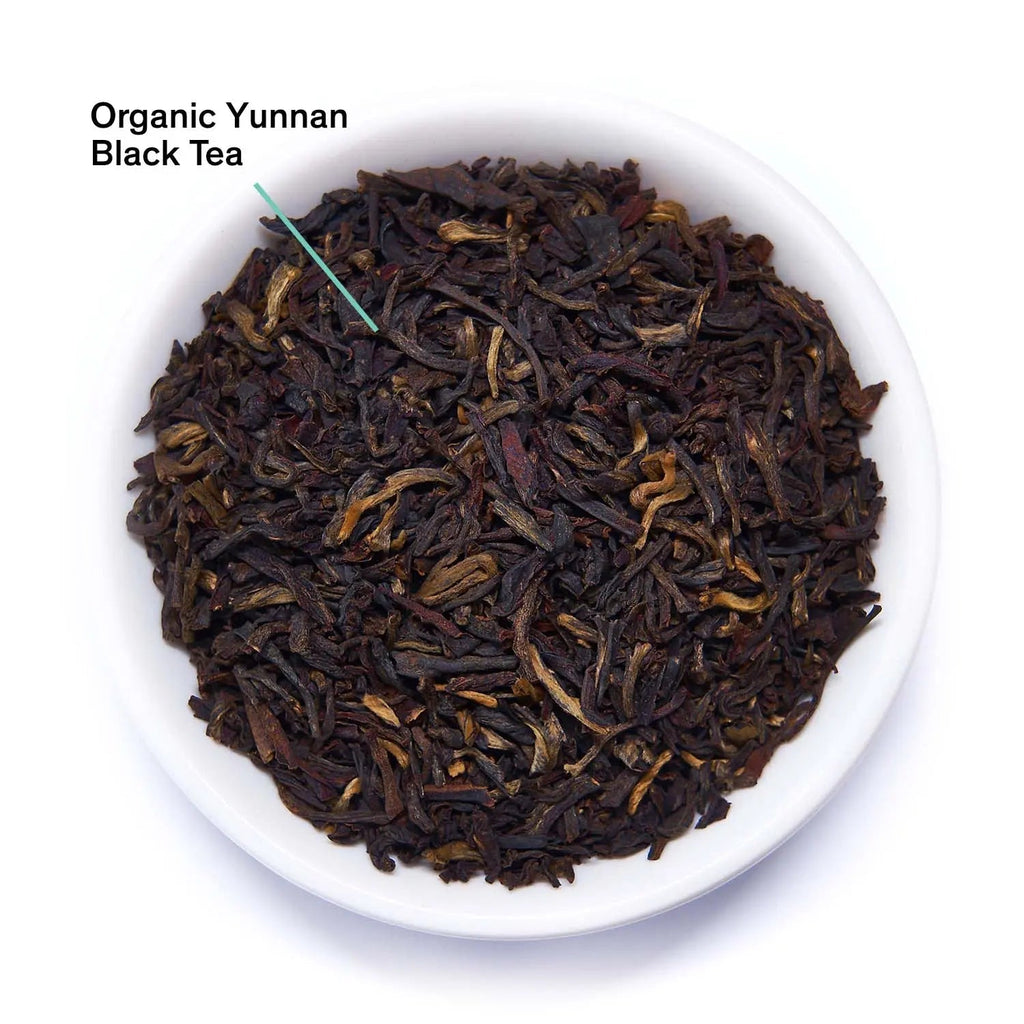Essentials Black Gold Black Tea box with 15 tea bags featuring organic Yunnan black tea and golden malty flavor