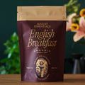 Essentials English Breakfast black tea packaging with organic South Indian tea bags and description of strong full-bodied flavor with bittersweet cocoa notes