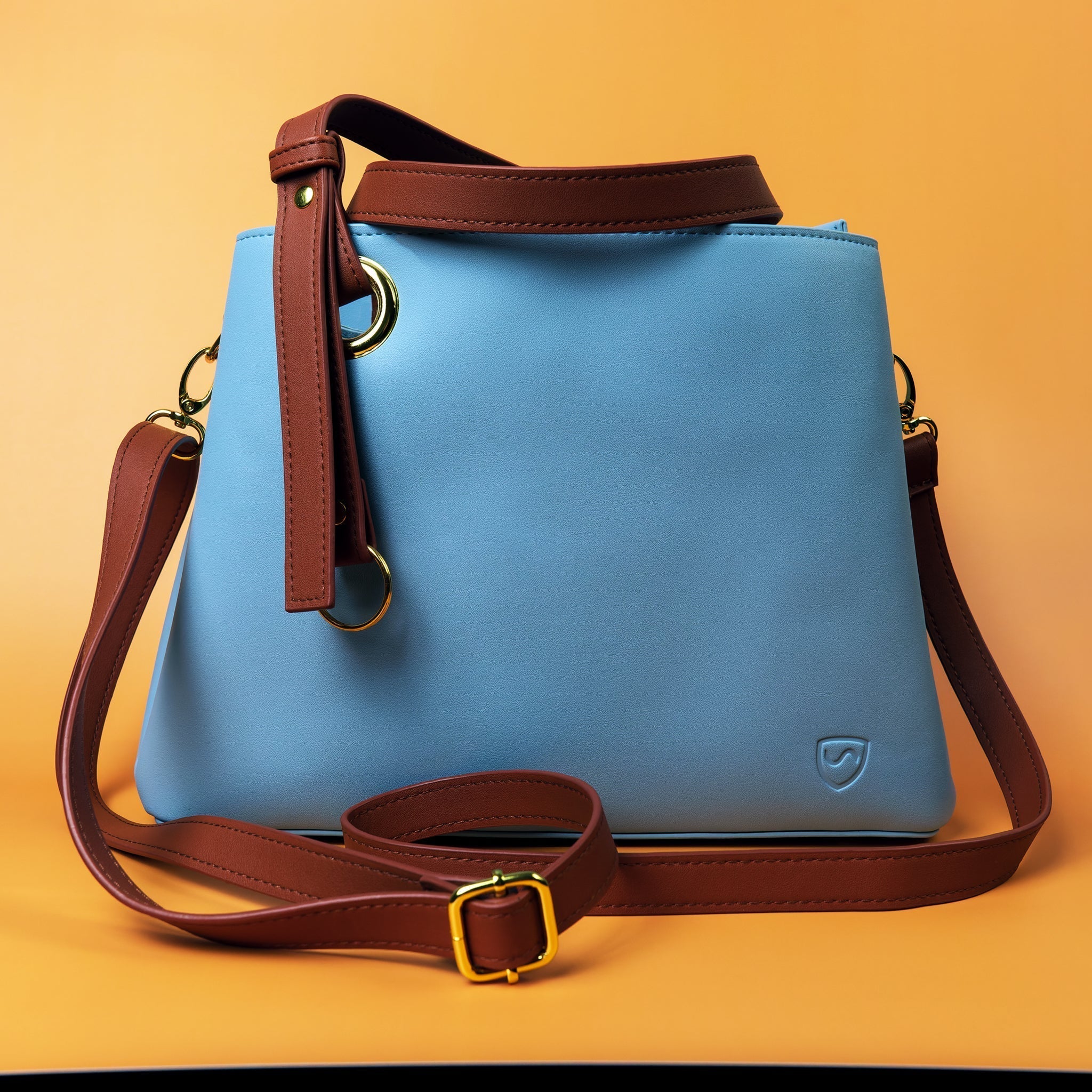 SYB Purse made with SaferBody to shield 99% of EMF radiation, features four compartments, vegan leather, and two carrying options.
